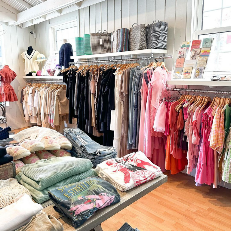 stylish clothes on racks and shelves at a boutique
